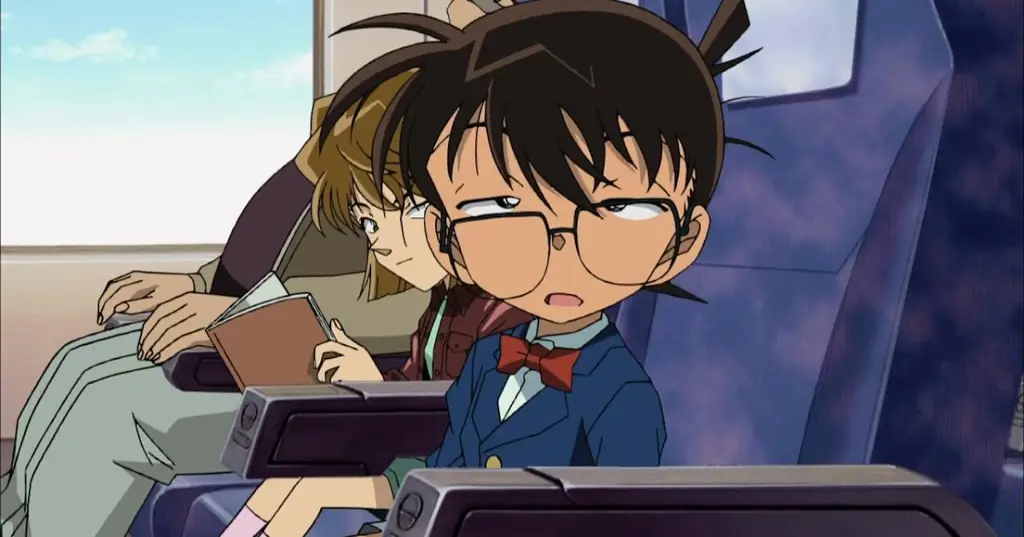 Menikmati Anime Detective Conan Gambar seseorang yang sedang menonton anime Detective Conan